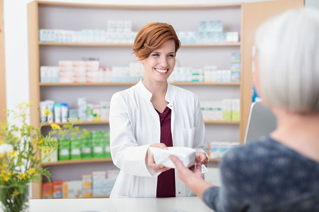 Pharmacist handing over prescription