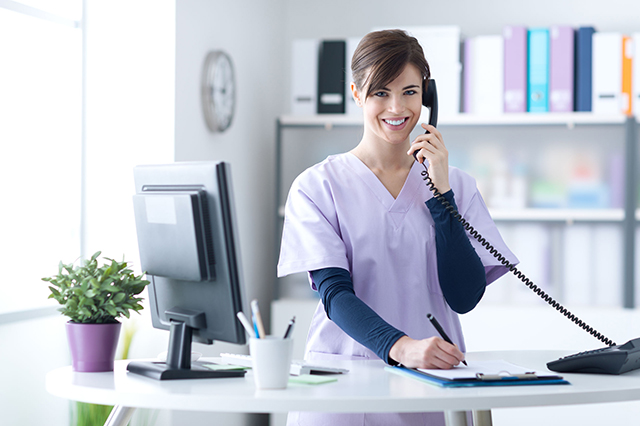 receptionist speaking on the telephine